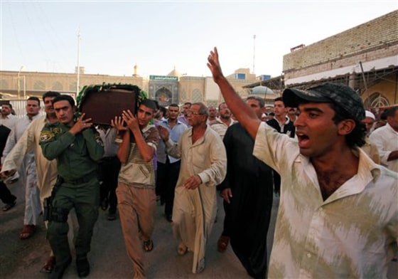 Mourners carry the coffin of a slain police major, targeted by gunmen with silenced pistols in Baghdad, for burial in the Shiite city of Najaf, Iraq, on Sept. 15. At least 12 slayings in Baghdad in the past two weeks have been linked to gangland-style hits using muffled weapons, including an off-duty policeman killed in a drive-by shooting on Sept. 27, officials say.